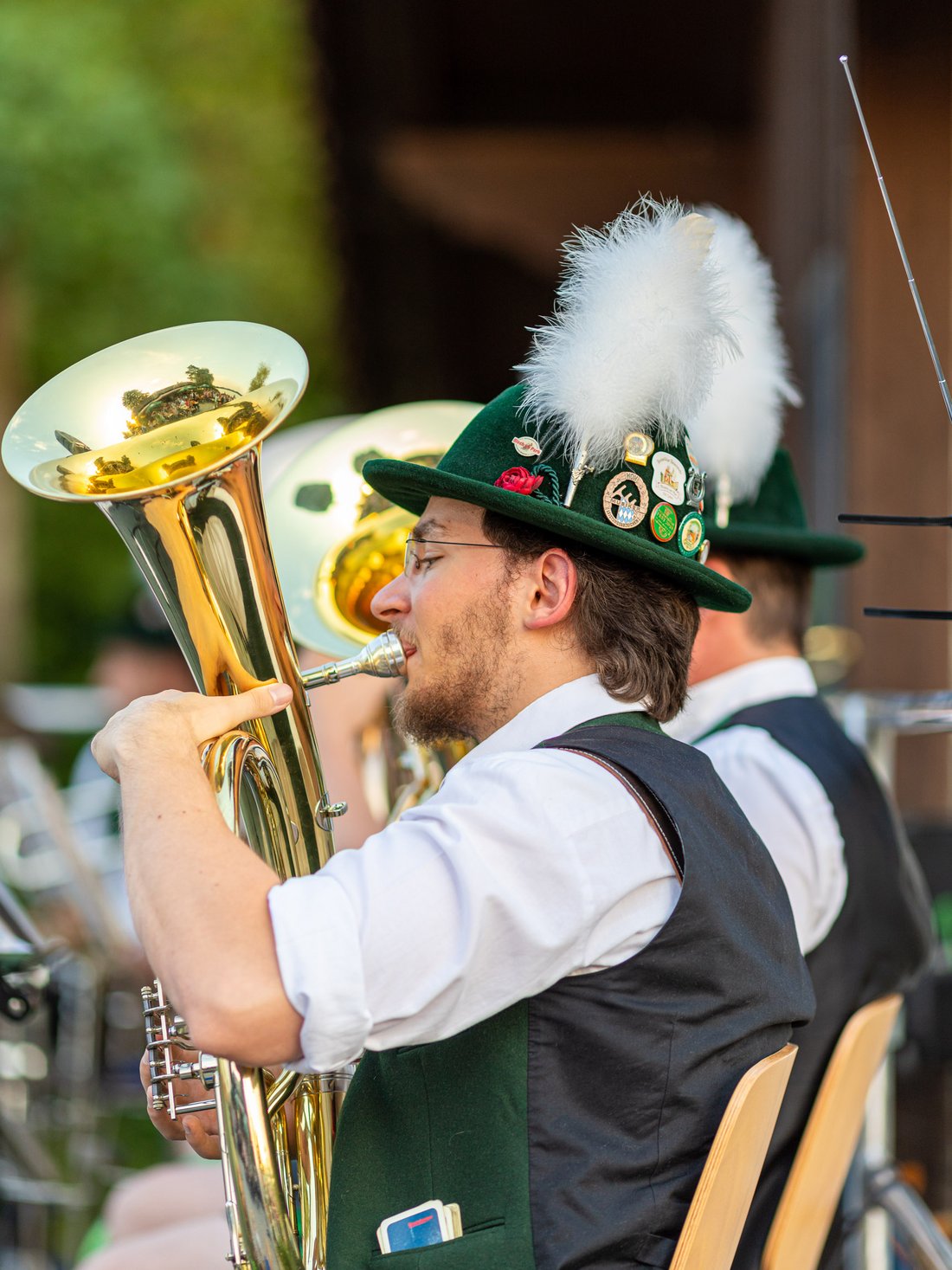 Musician with traditional Bavarian costume plays the baritone